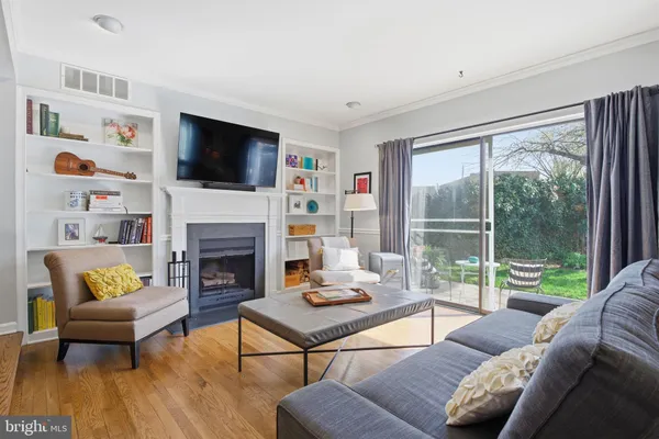 a living room with furniture fireplace and a flat screen tv