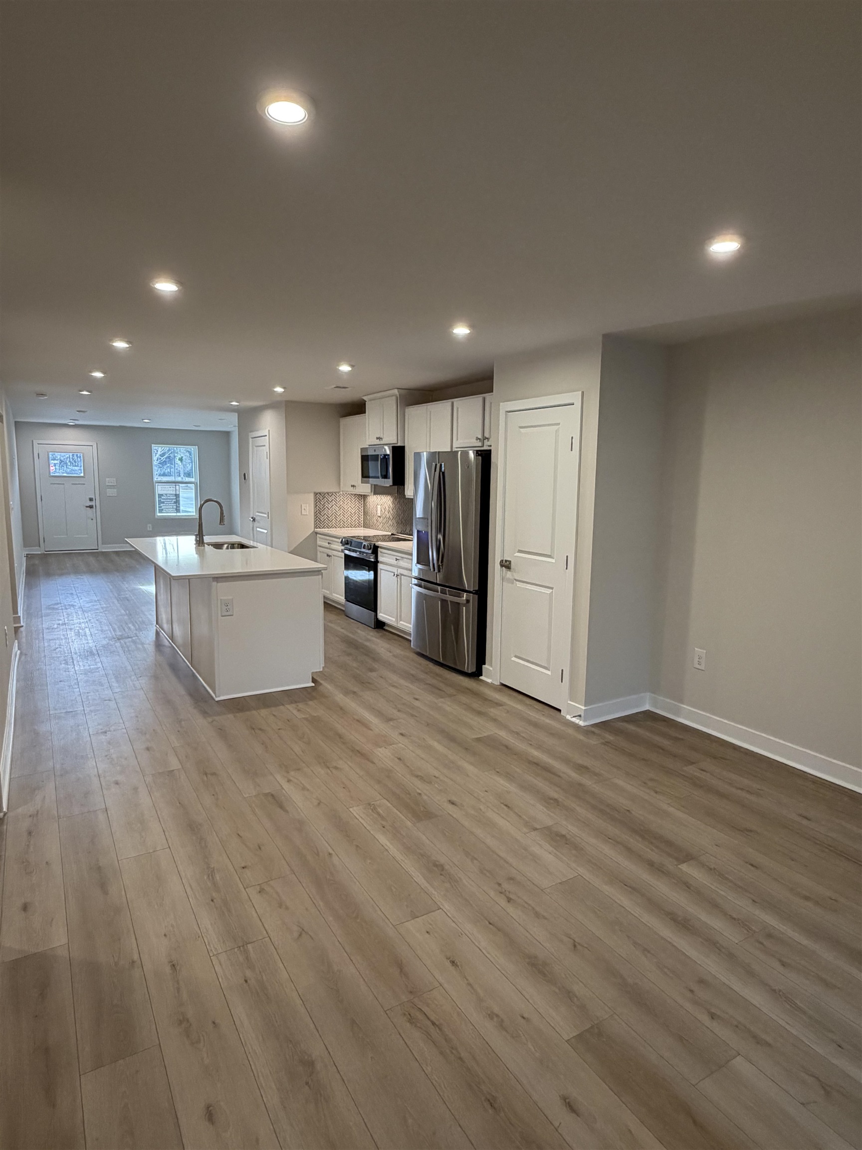 1303 Pleasant View Drive, Unit B North Myrtle Beach, SC 29582 - Photo 13 of 13 Kitchen featuring open floor plan, a kitchen island with sink, recessed lighting, white cabinetry, and stainless steel appliances