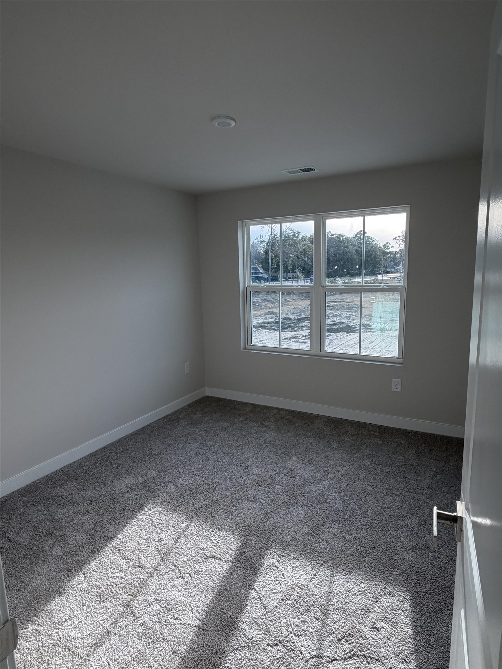 1303 Pleasant View Drive, Unit B North Myrtle Beach, SC 29582 - Photo 9 of 13 Carpeted spare room with baseboards