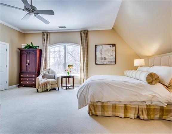 5 Granville Road Lincoln, MA 01773 - Photo 21 of 30 a bedroom with a bed and a chandelier