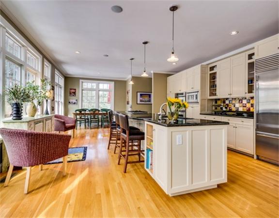 5 Granville Road Lincoln, MA 01773 - Photo 10 of 30 a kitchen with stainless steel appliances granite countertop a refrigerator a stove top oven a dining table and chairs with wooden floor