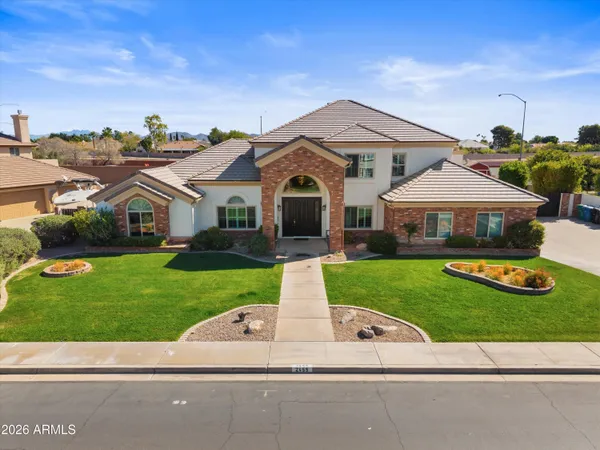 a front view of a house with a garden and plants