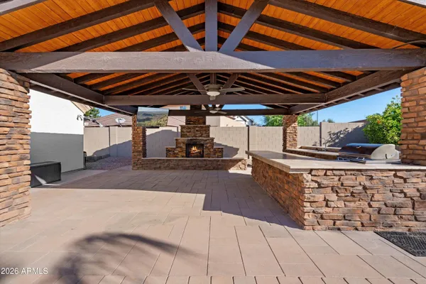 a kitchen with kitchen island a counter top space a sink stainless steel appliances and cabinets