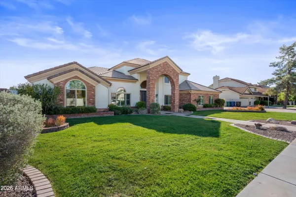a bathroom with a granite countertop tub a sink and a window