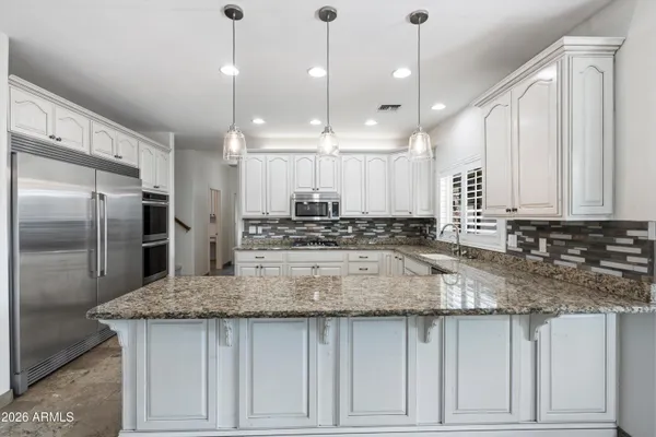 a front view of a house with yard and green space