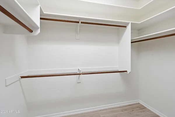 a view of walk in closet with empty racks