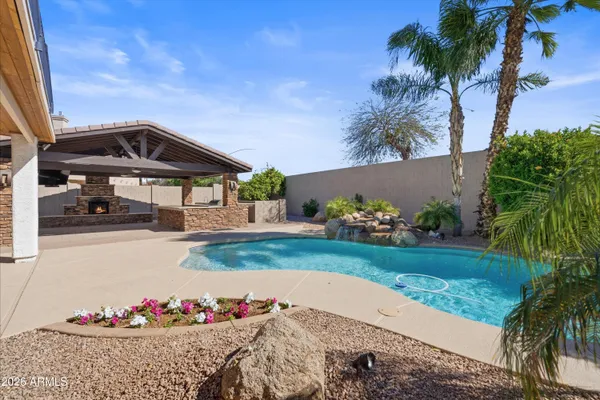 a view of empty room with fireplace and wooden floor