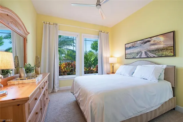 a bedroom with a large bed and a large window