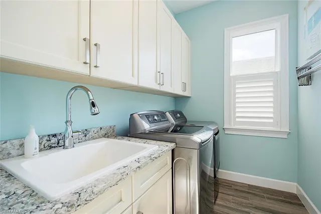 a kitchen with granite countertop a sink a stove and cabinets
