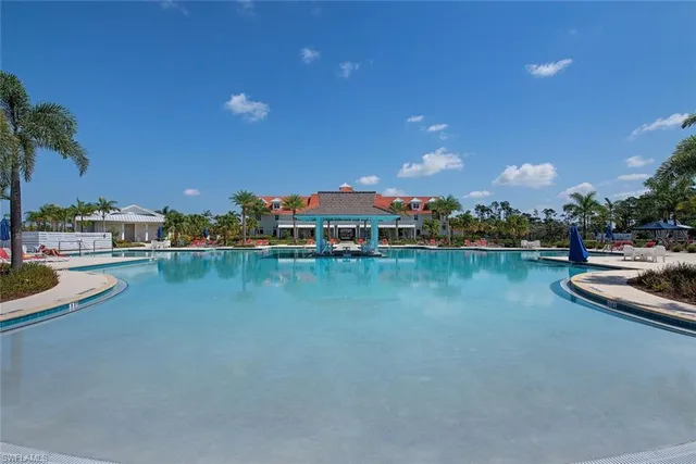 a view of deck with chairs and table under an umbrella