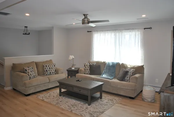 a living room with furniture and a large window