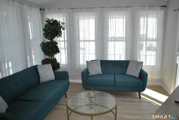 a living room with furniture and a large window