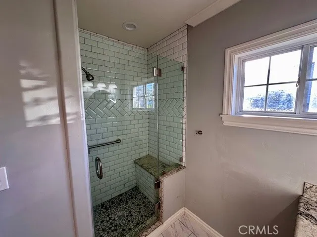 a bathroom with a toilet and a shower