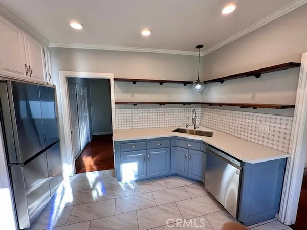 a kitchen with stainless steel appliances granite countertop a sink and cabinets