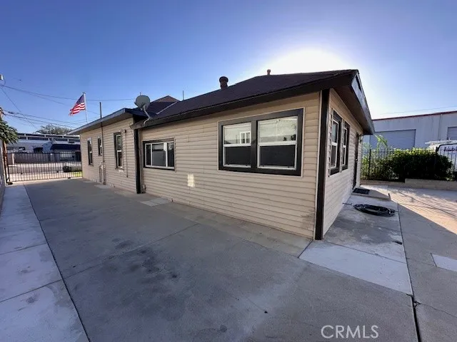 a view of a house with a small yard and parking space