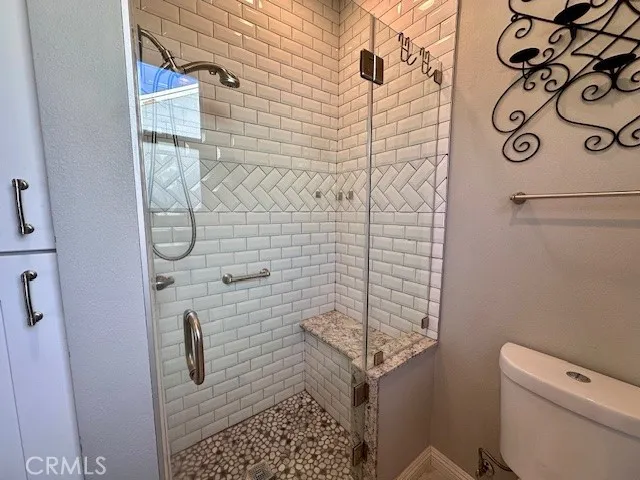 a bathroom with a toilet and shower