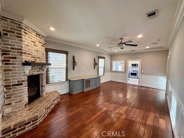a view of an empty room with a fireplace and a window
