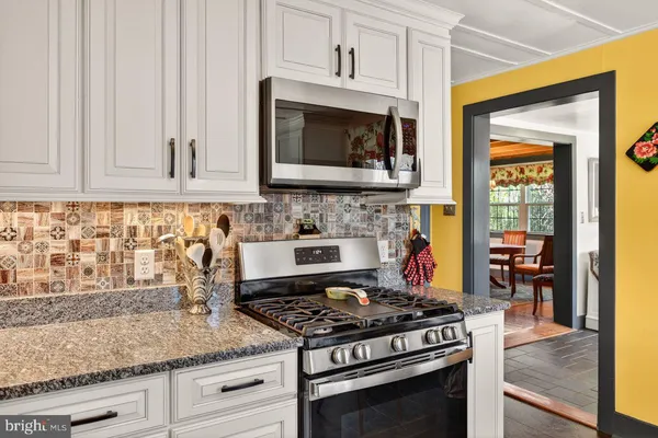 a kitchen with granite countertop a stove and a sink