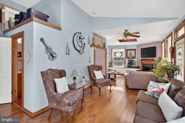 a living room with furniture potted plant and a window