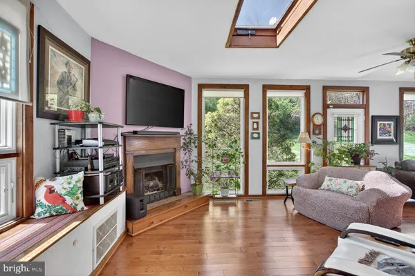 a living room with furniture a flat screen tv and a fireplace