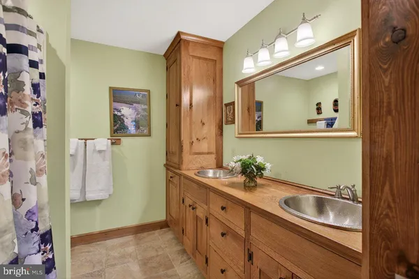 a bathroom with a sink mirror and vanity