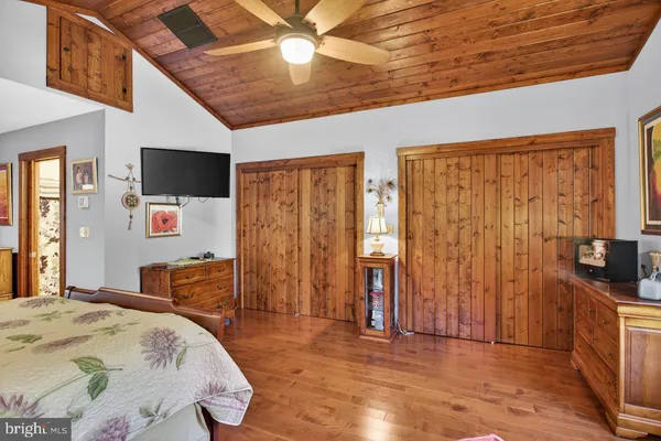a bedroom with furniture and a flat screen tv
