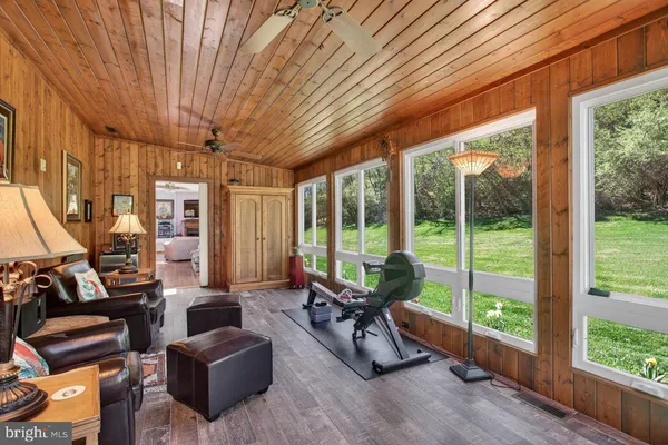a living room with furniture and a floor to ceiling window