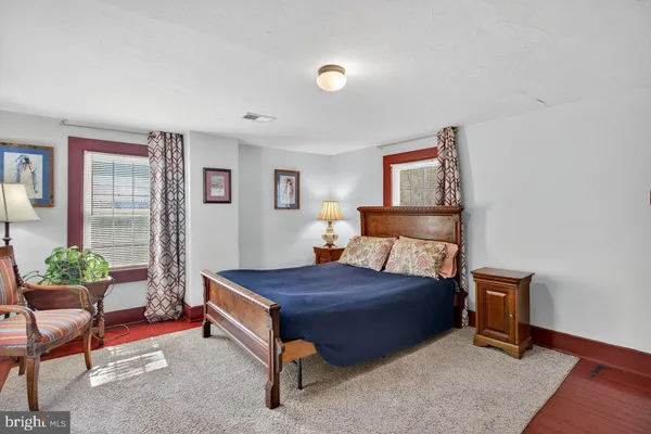 a bedroom with a bed and a couch