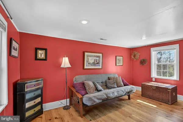 a living room with furniture a flat screen tv and a window