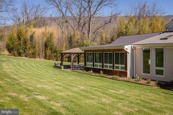 a view of a house with backyard and porch