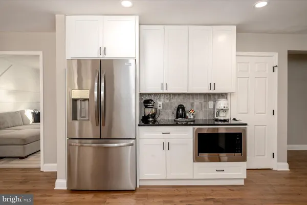 a kitchen with a refrigerator sink and cabinets