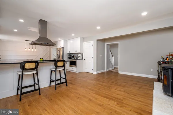 an open kitchen with dining table and chairs