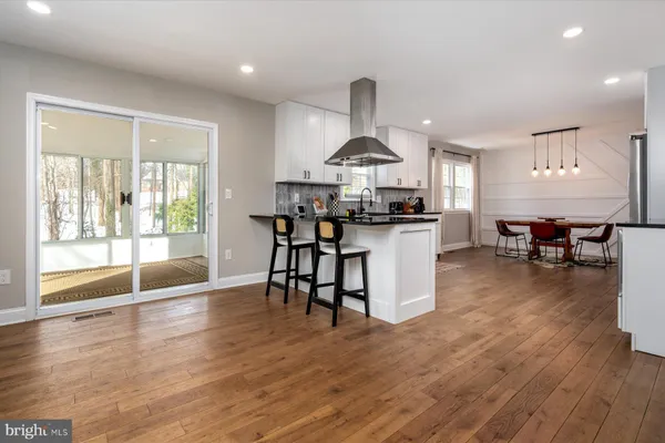 a living room with furniture wooden floor and a table