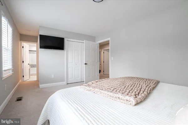 a bedroom with a bed and a television