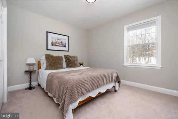 a bedroom with bed and a window