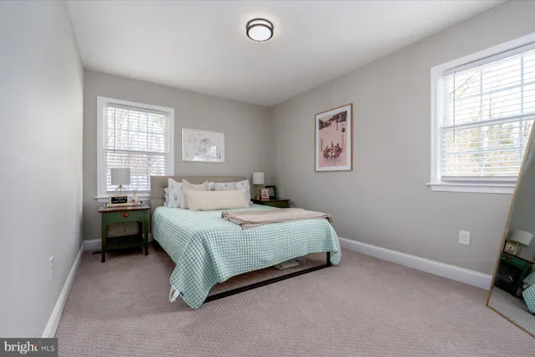 a spacious bedroom with a bed and a window