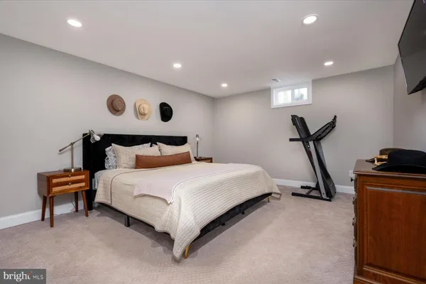 a bedroom with bed and a chandelier