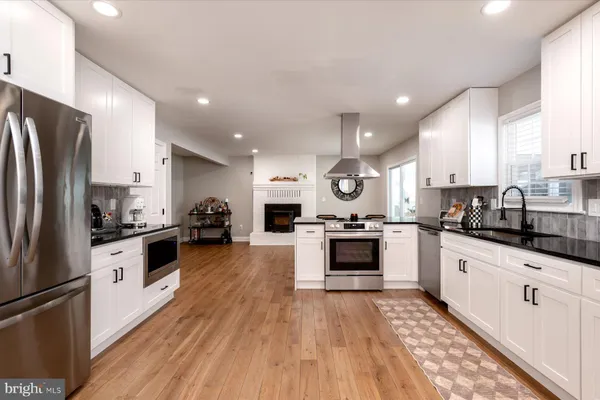 a large kitchen with stainless steel appliances and a refrigerator