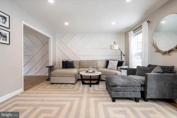 a living room with furniture and a large mirror