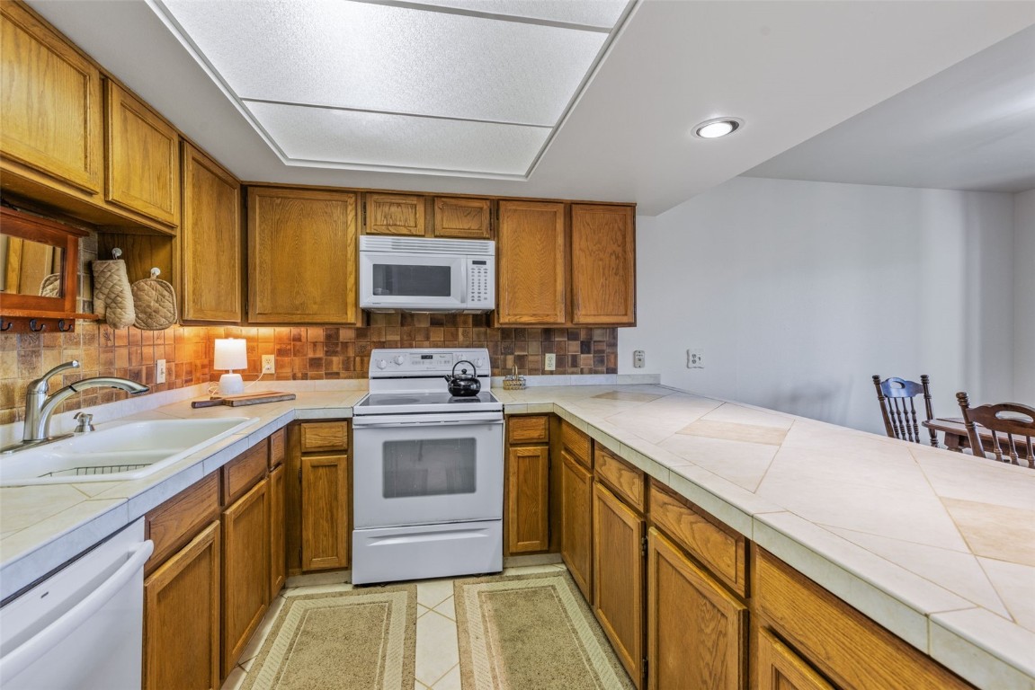 4624 Ryan Gulch Road, Unit 4624 Silverthorne, CO 80498 - Photo 12 of 31 a kitchen with a sink stove and cabinets