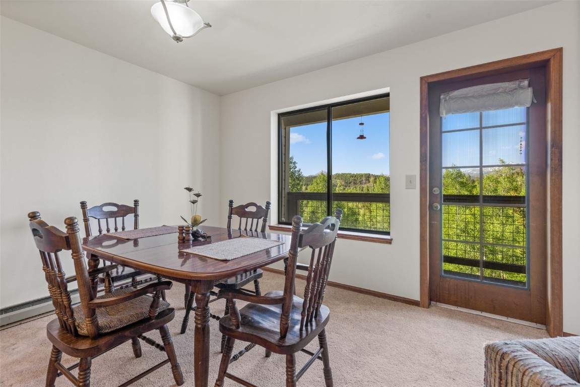 4624 Ryan Gulch Road, Unit 4624 Silverthorne, CO 80498 - Photo 14 of 31 a view of a dining room with furniture window and outside view