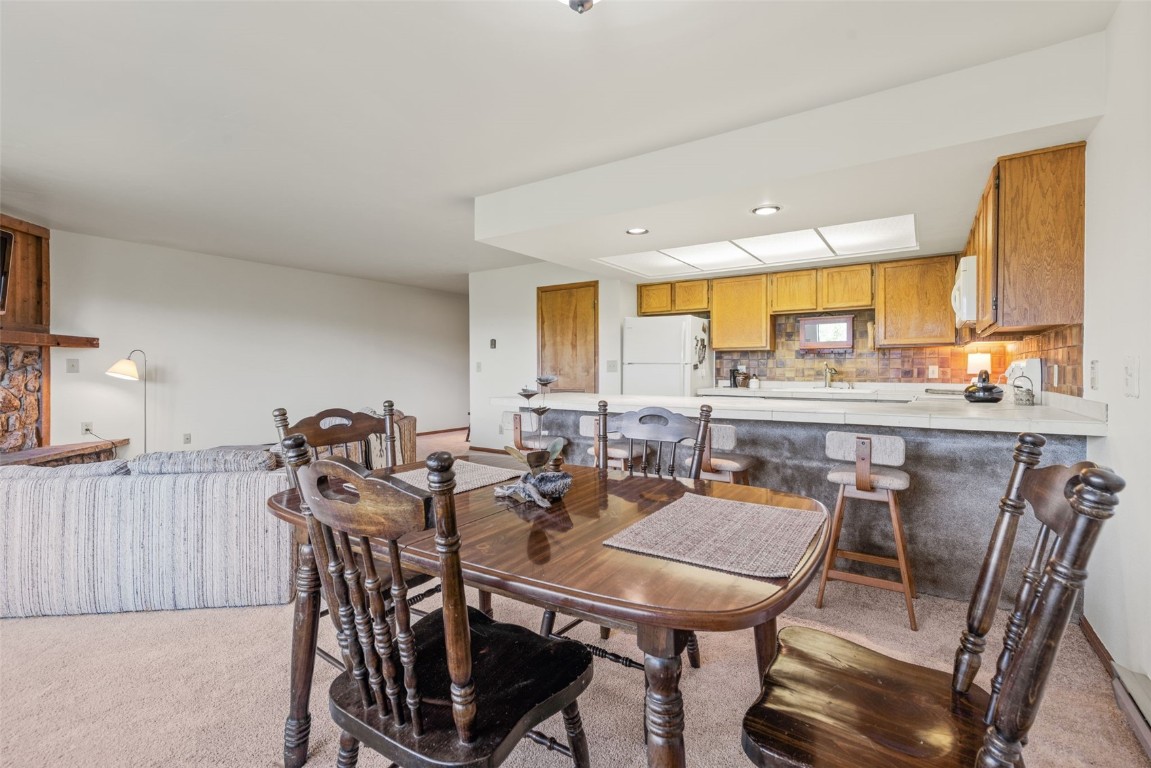 4624 Ryan Gulch Road, Unit 4624 Silverthorne, CO 80498 - Photo 15 of 31 a view of a dining room with furniture