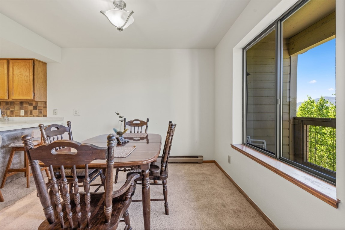 4624 Ryan Gulch Road, Unit 4624 Silverthorne, CO 80498 - Photo 16 of 31 a view of a dining room with furniture and window
