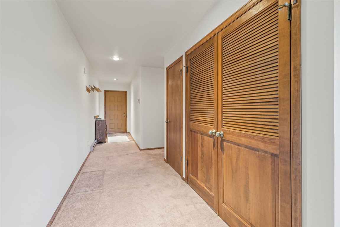 4624 Ryan Gulch Road, Unit 4624 Silverthorne, CO 80498 - Photo 19 of 31 a view of a hallway with wooden shelves