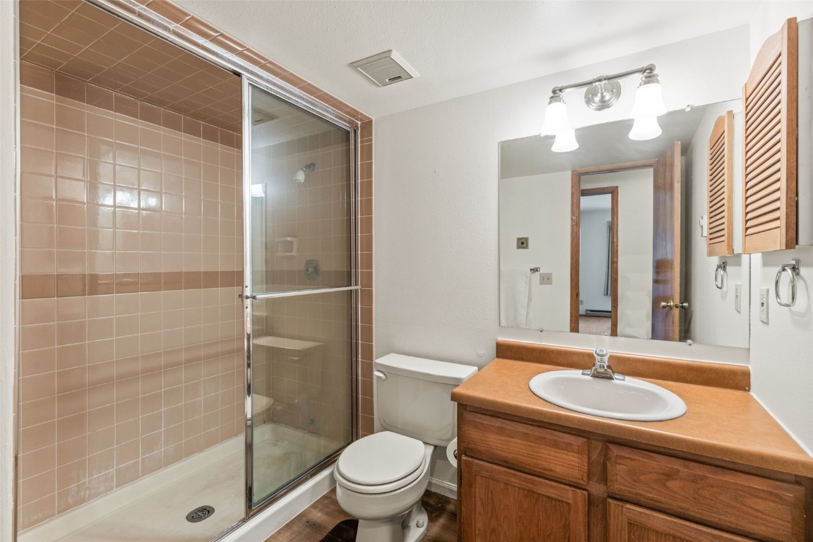 4624 Ryan Gulch Road, Unit 4624 Silverthorne, CO 80498 - Photo 21 of 31 a bathroom with a sink toilet and shower