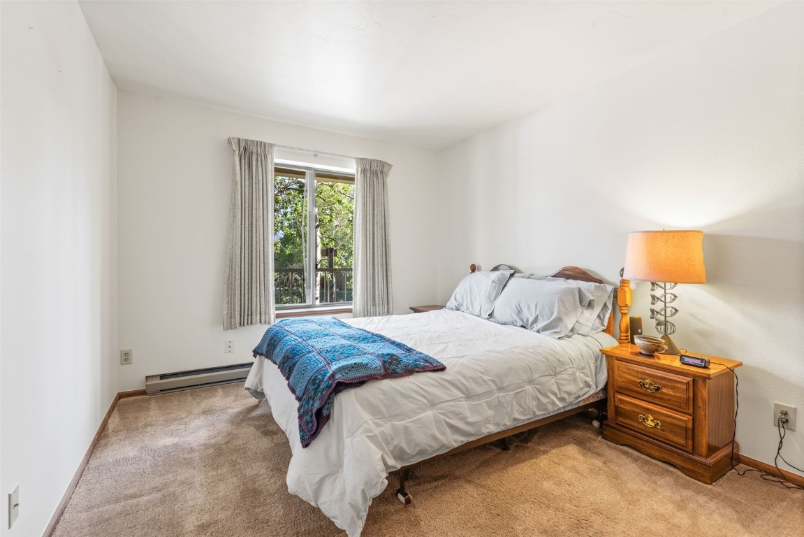 4624 Ryan Gulch Road, Unit 4624 Silverthorne, CO 80498 - Photo 25 of 31 a bedroom with a bed and a window