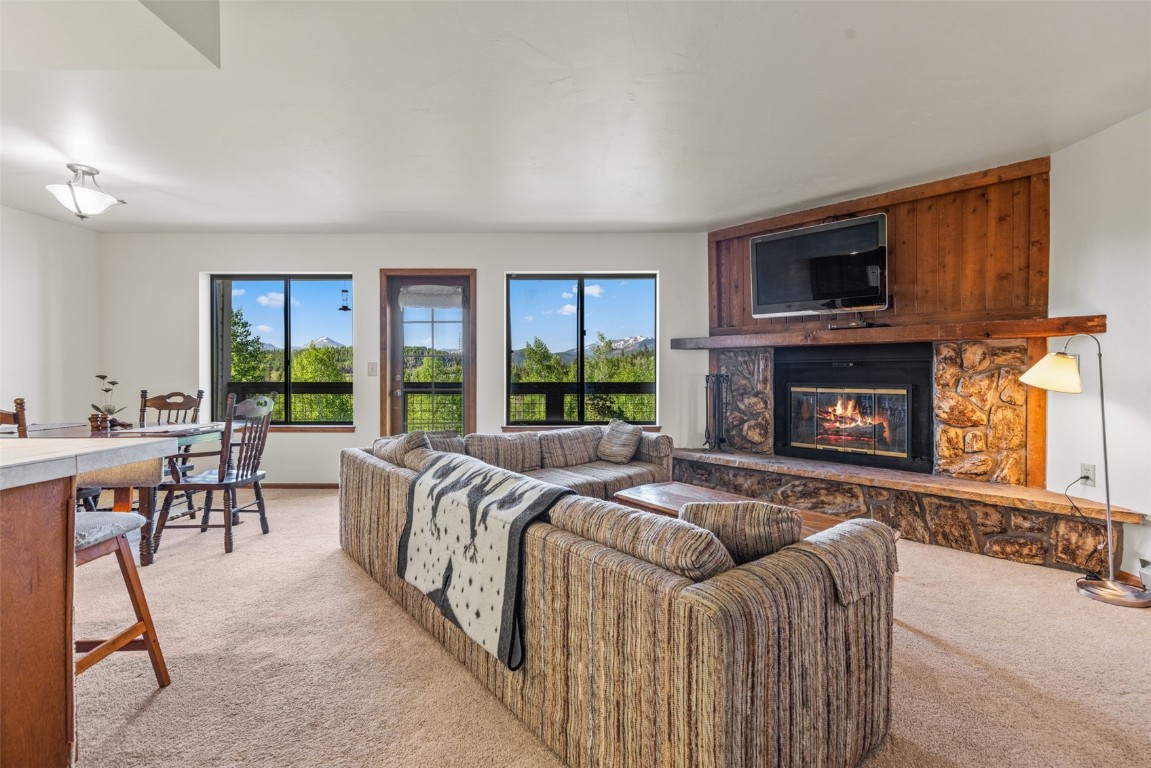 4624 Ryan Gulch Road, Unit 4624 Silverthorne, CO 80498 - Photo 6 of 31 a bed room with a bed and a fireplace