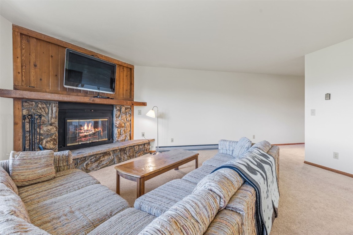 4624 Ryan Gulch Road, Unit 4624 Silverthorne, CO 80498 - Photo 7 of 31 a living room with furniture and a fireplace