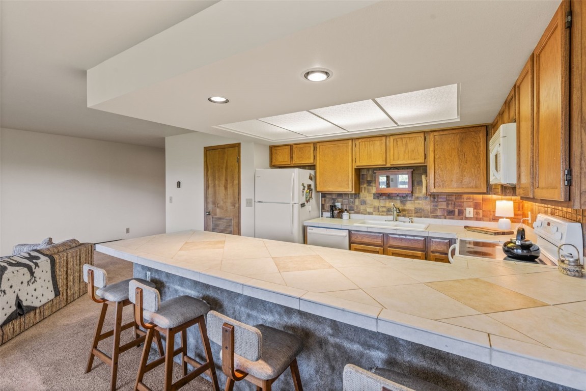4624 Ryan Gulch Road, Unit 4624 Silverthorne, CO 80498 - Photo 10 of 31 a living room with stainless steel appliances kitchen island granite countertop furniture and a large window