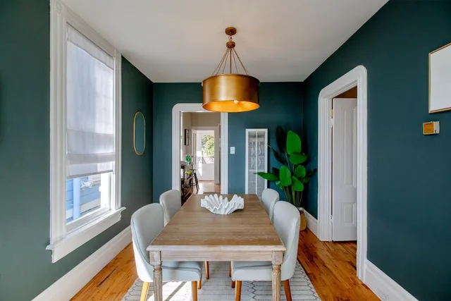 a view of a dining room with a table and chairs